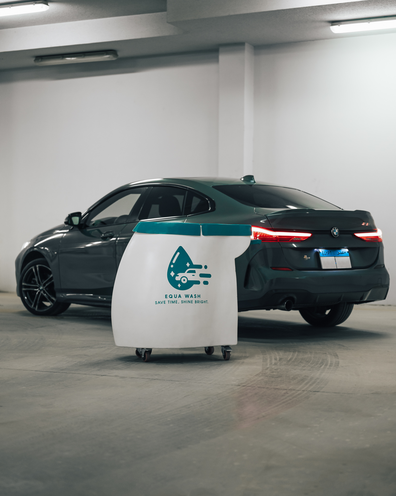 Equa Wash cart beside a BMW in a commercial underground parking garage