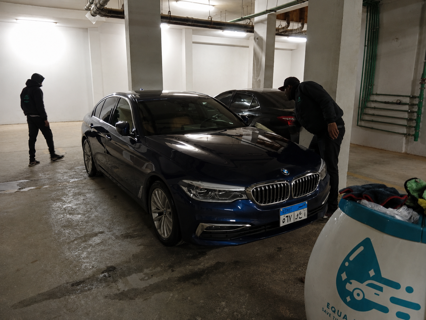 Equa Wash cart and team beside a BMW 5 Series in an underground garage