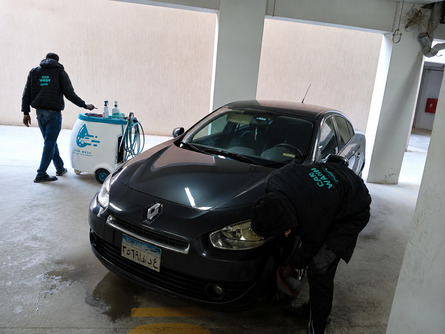 Equa Wash branded cart beside a Renault in an underground parking lot